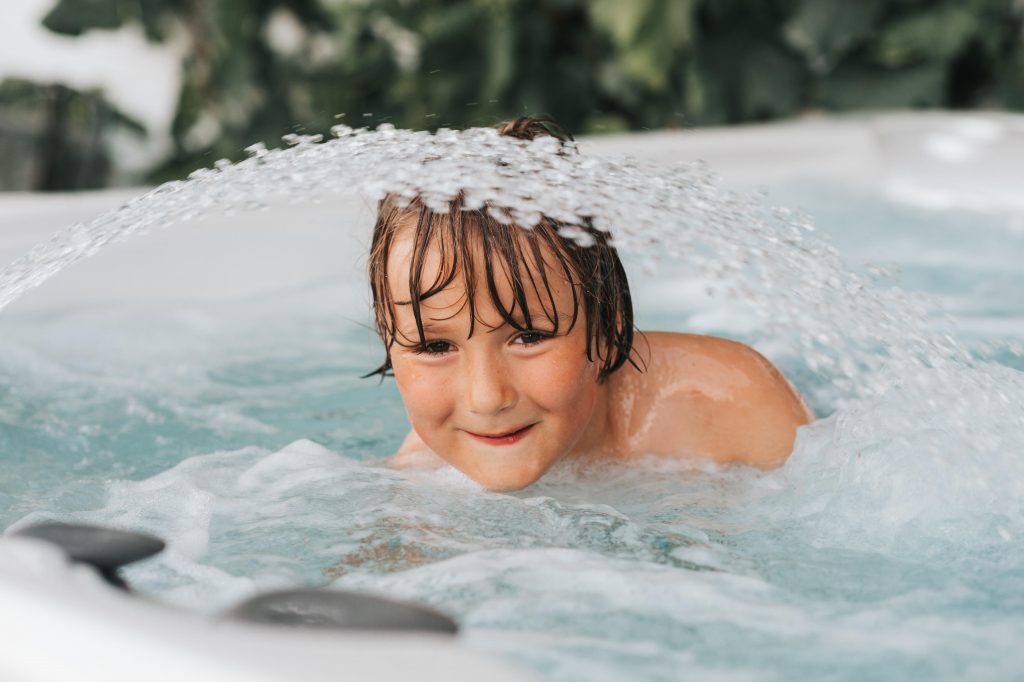 handsome-little-boy-enjoying-warm-water-in-jacuzzi-pool-clinic